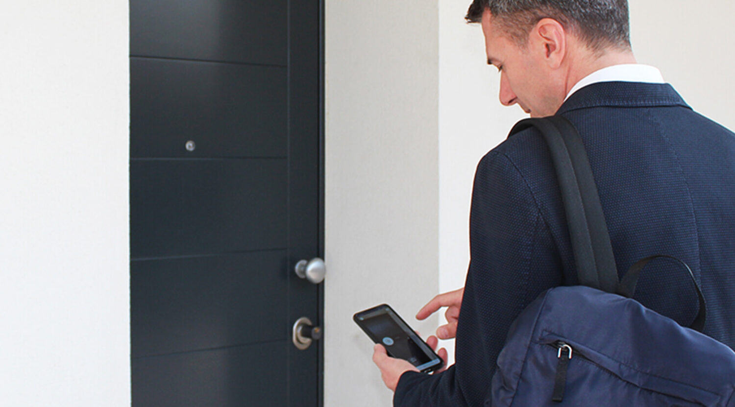 Self check-in legal requirements: guest opening a rental door with a smartphone after remote identity verification